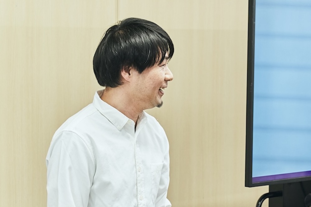 タキザワさんがワークショップの終盤に全体に向けて笑顔で話している